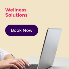 An image of a person working on a laptop with text reading: 'Workplace Wellness Clinics' and a 'Book Now' button.