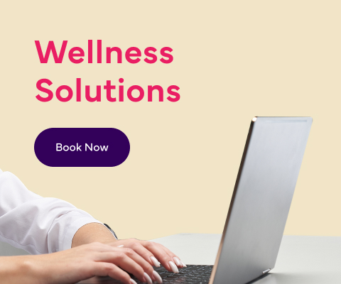 An image of a person working on a laptop with text reading: 'Workplace Wellness Clinics' and a 'Book Now' button.